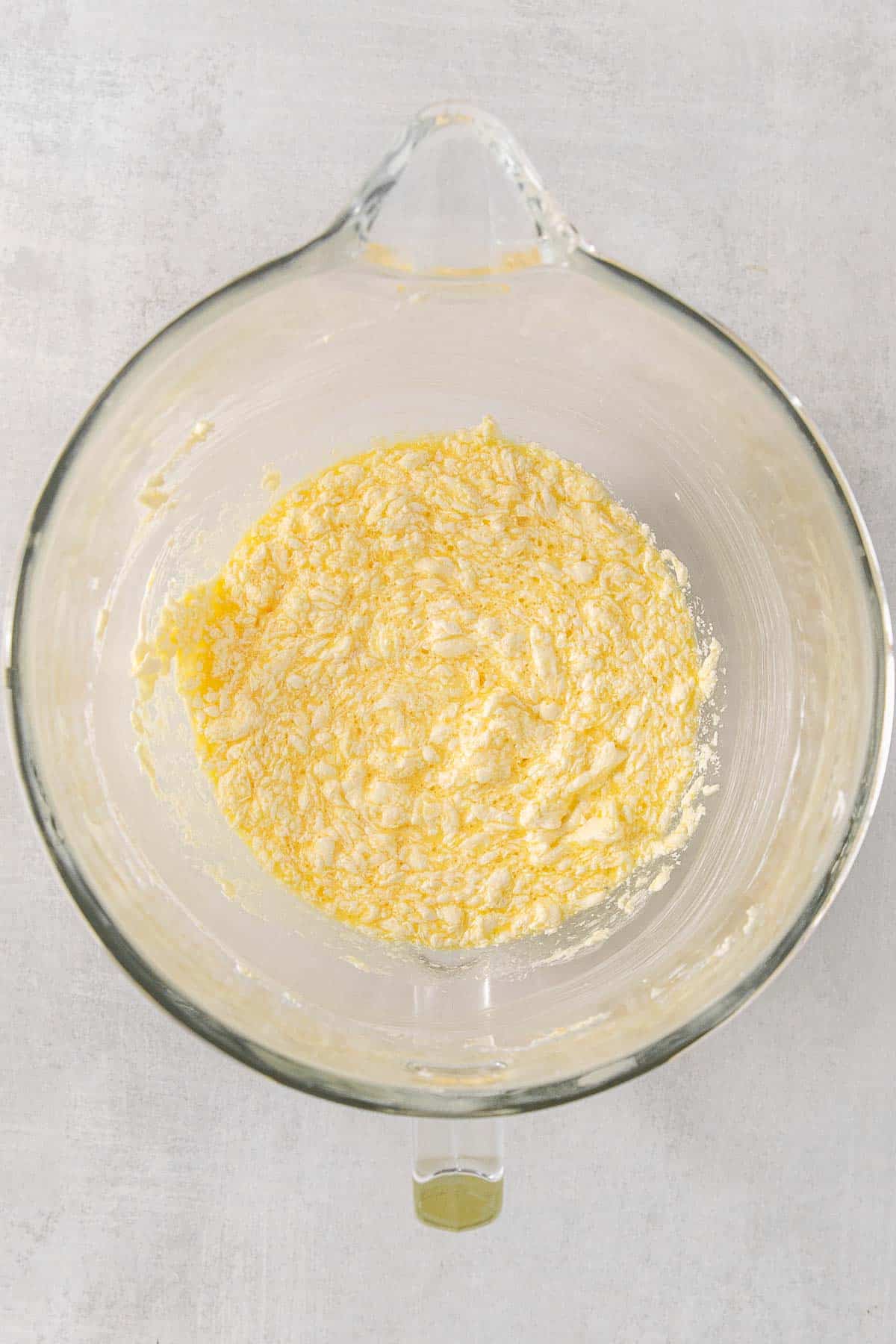 Glass mixing bowl with butter mixture.