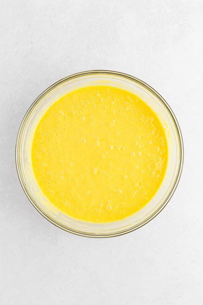 Lemon cake batter in a glass mixing bowl.