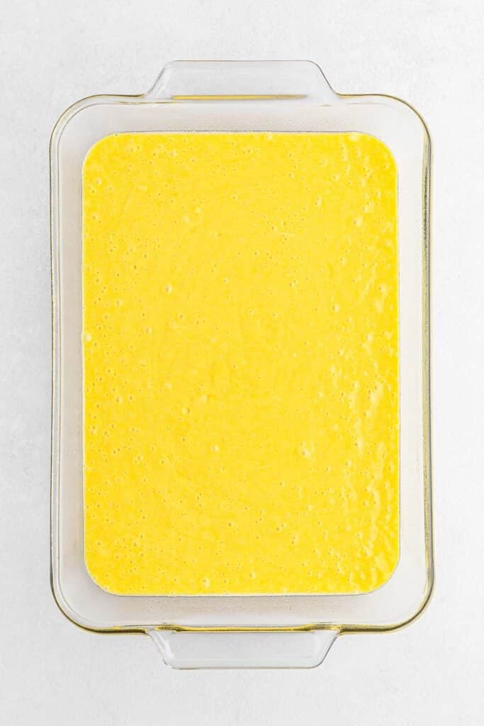 Lemon cake batter poured into a rectangle baking dish.