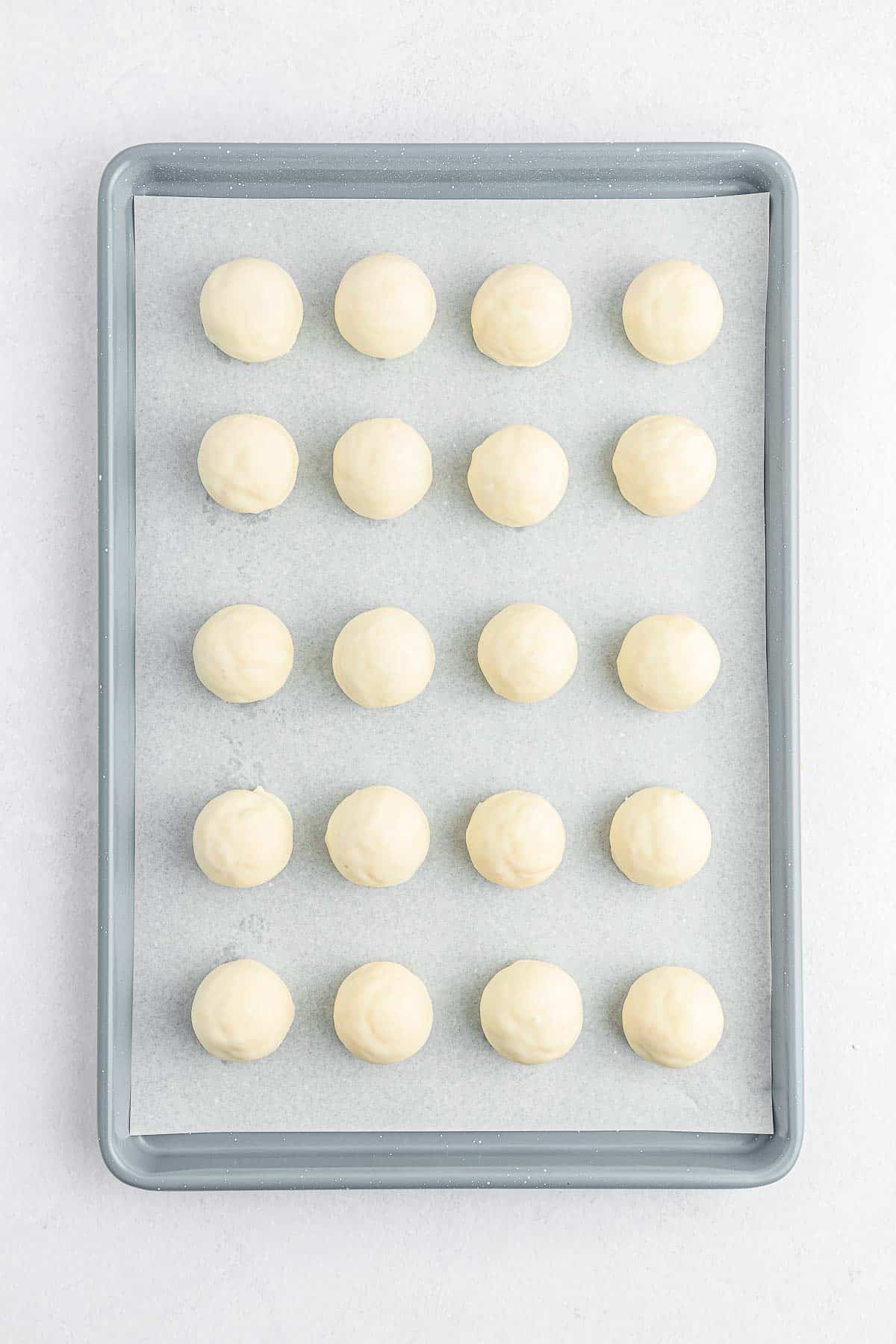 Lemon cake balls on a baking sheet.