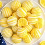 Overhead shot of lemon cake balls on a white plate.