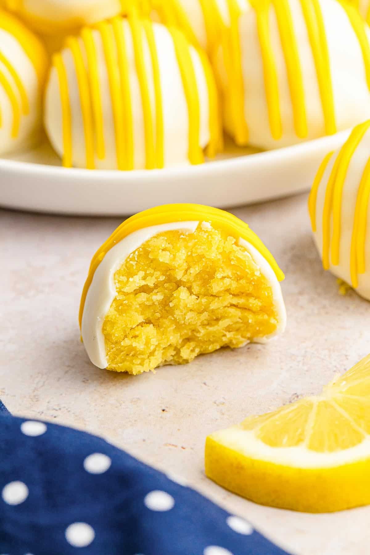 Close up of lemon cake ball with a bite taken.