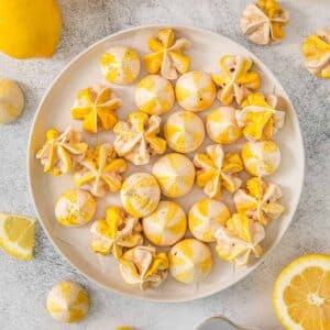 Multiple lemon meringue on a white plate.