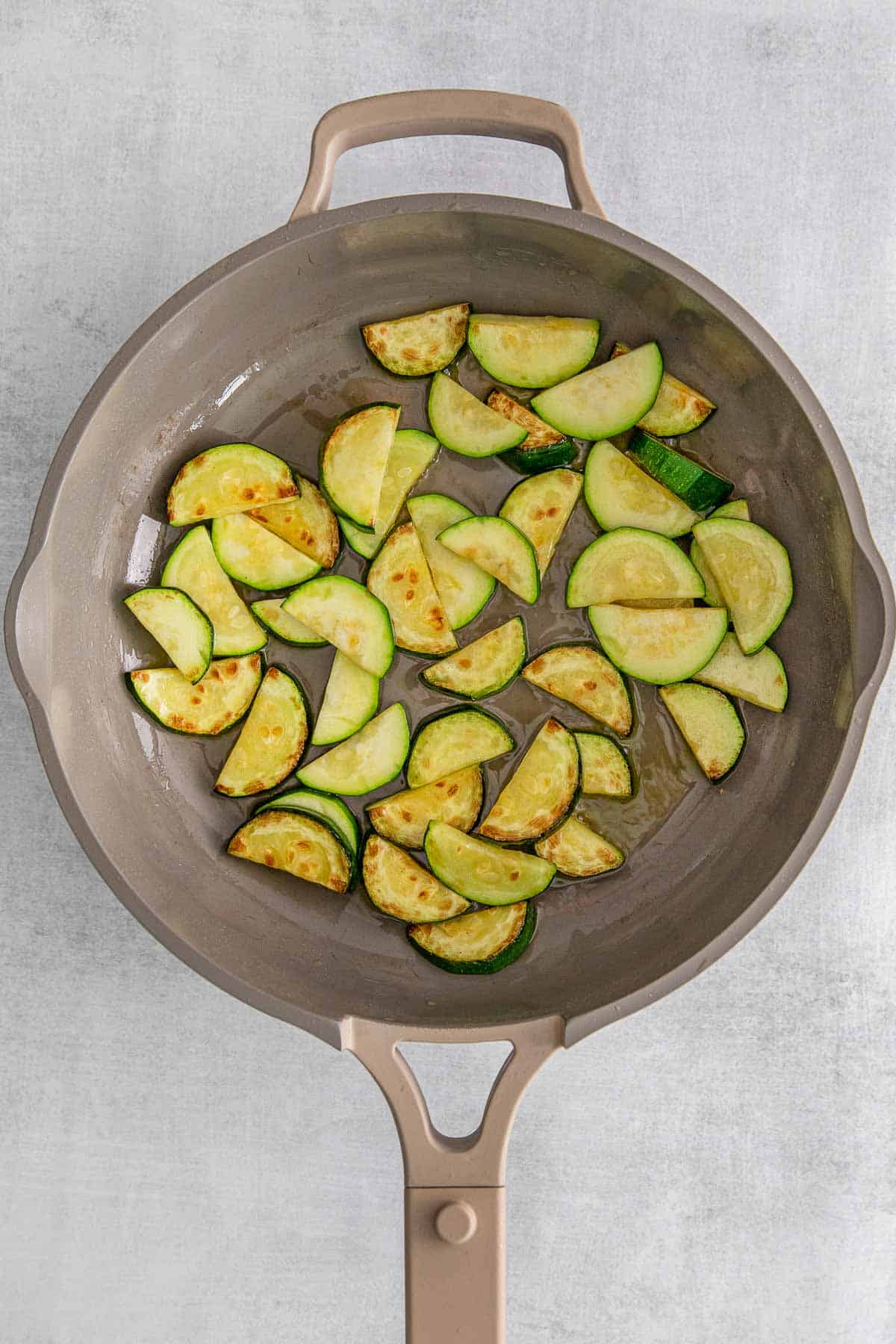 Pan full of cooked zucchini.
