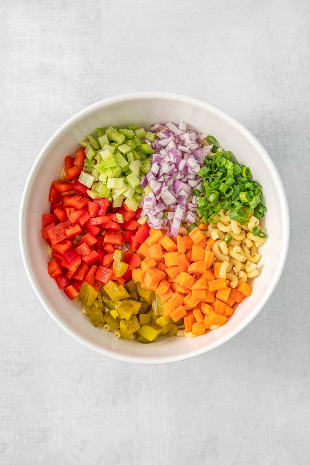 Macaroni Salad ingredients added to large white mixing bowl.