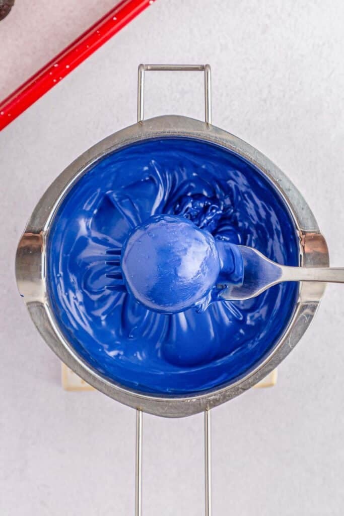 Blue oreo ball dipped into blue candy melt.