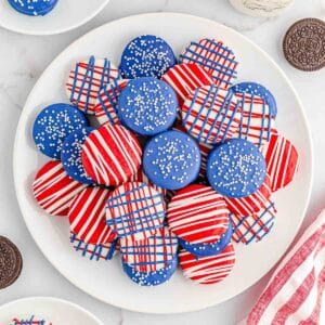 Multiple patriotic oreos stacked on a large white plate.