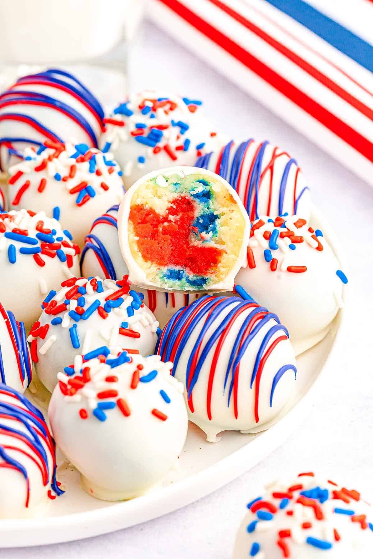 white plate full of red white and blue cake balls