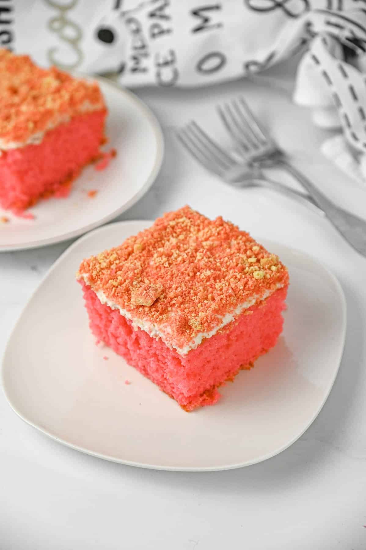 Slice of strawberry crunch cake on a white plate.