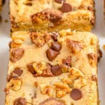 closeup of peanut butter cup cookie bars cut on a plate.