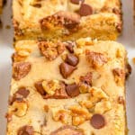 closeup of peanut butter cup cookie bars cut on a plate.