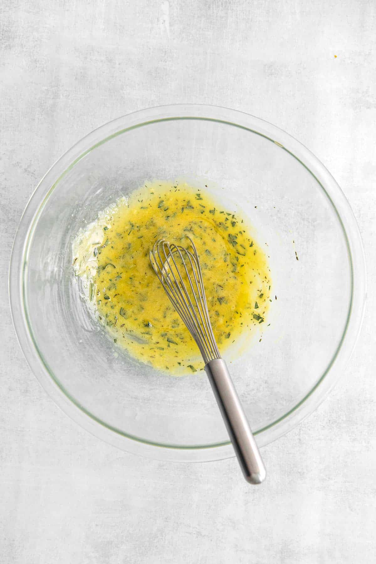 Olive oil mix in a large glass mixing bowl.