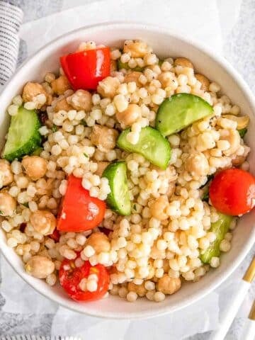 Mediterranean couscous salad in a white bowl.