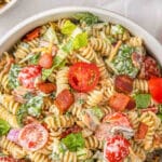 BLT pasta salad in a white bowl with text overlay that reads Beset BLT pasta salad.