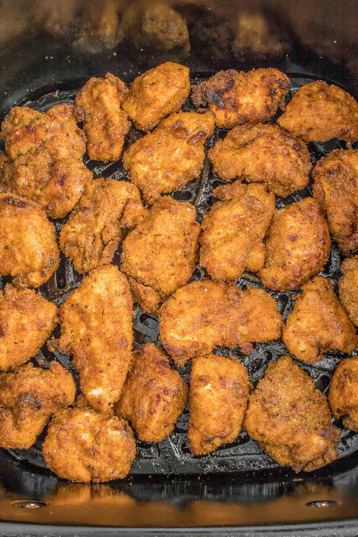 Chicken nuggets in bottom of air fryer.
