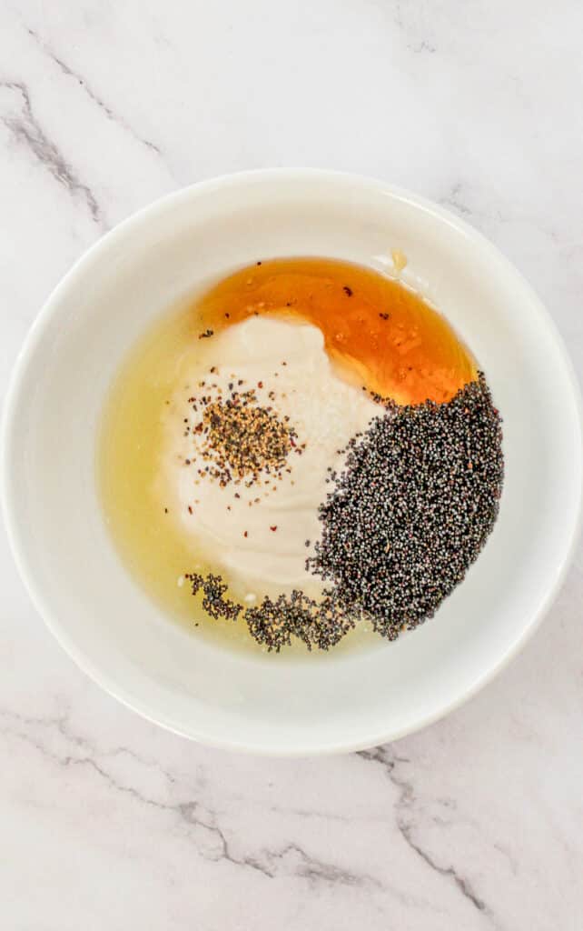 Yogurt dressing ingredients in a large white mixing bowl.