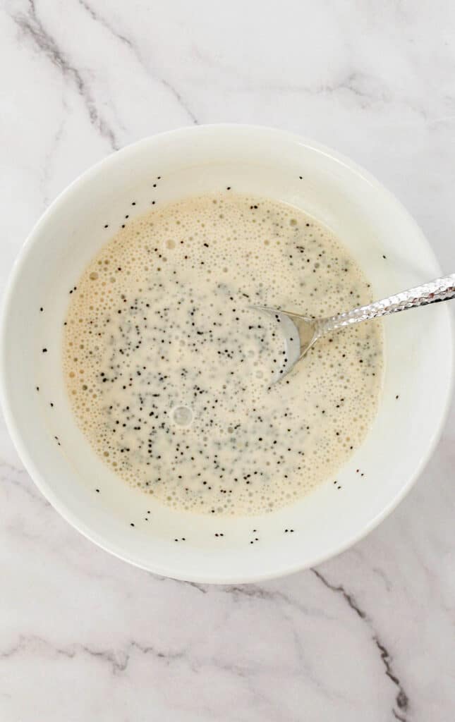 Yogurt dressing in a large white mixing bowl.