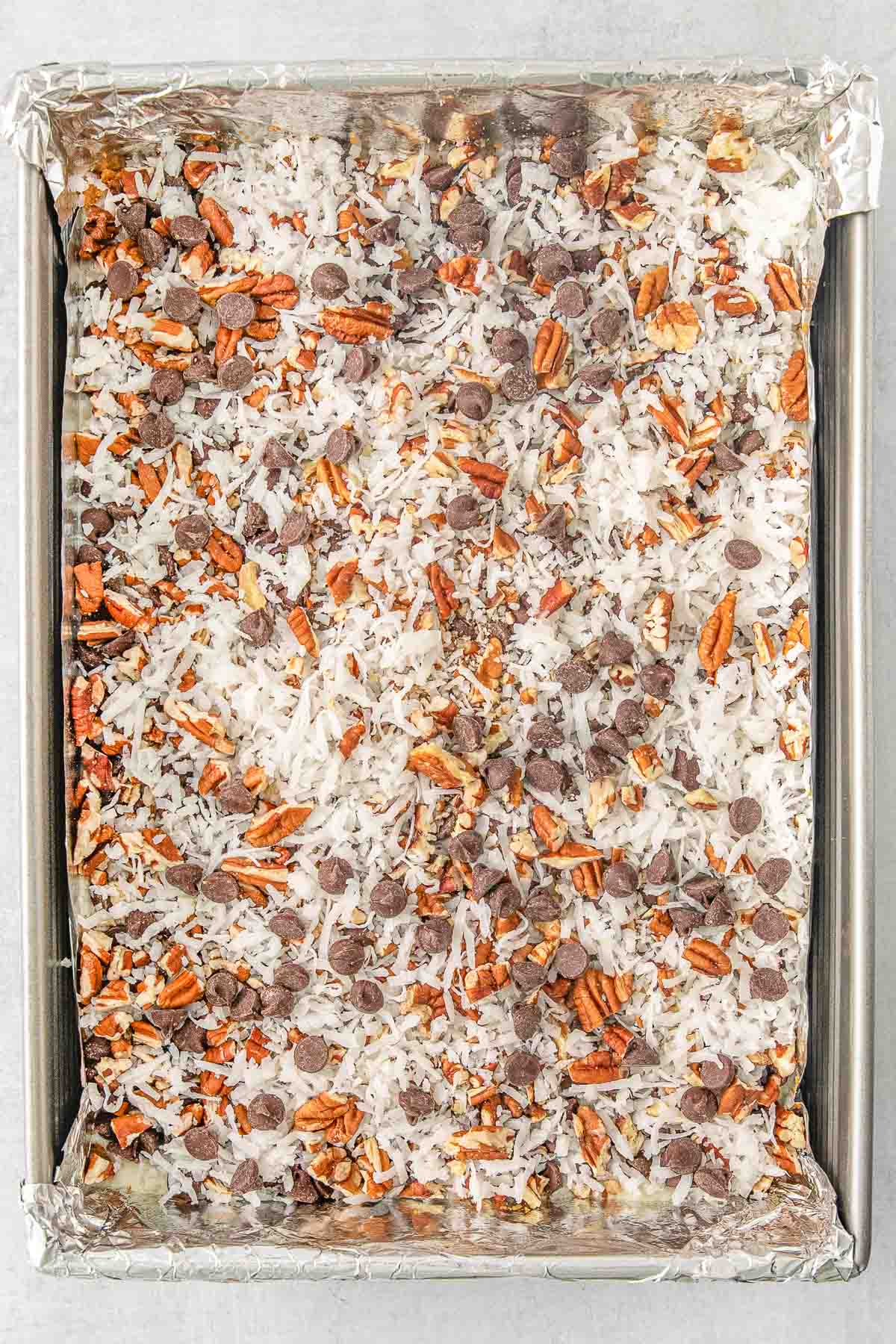 Baking sheet containing uncooked cookie bars.