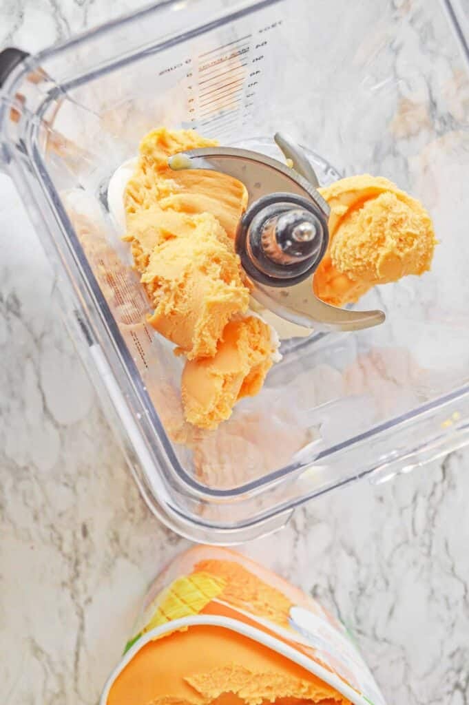 Orange sherbet added into blender.