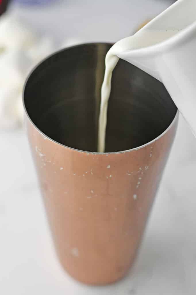 Heavy cream added to cocktail shaker.