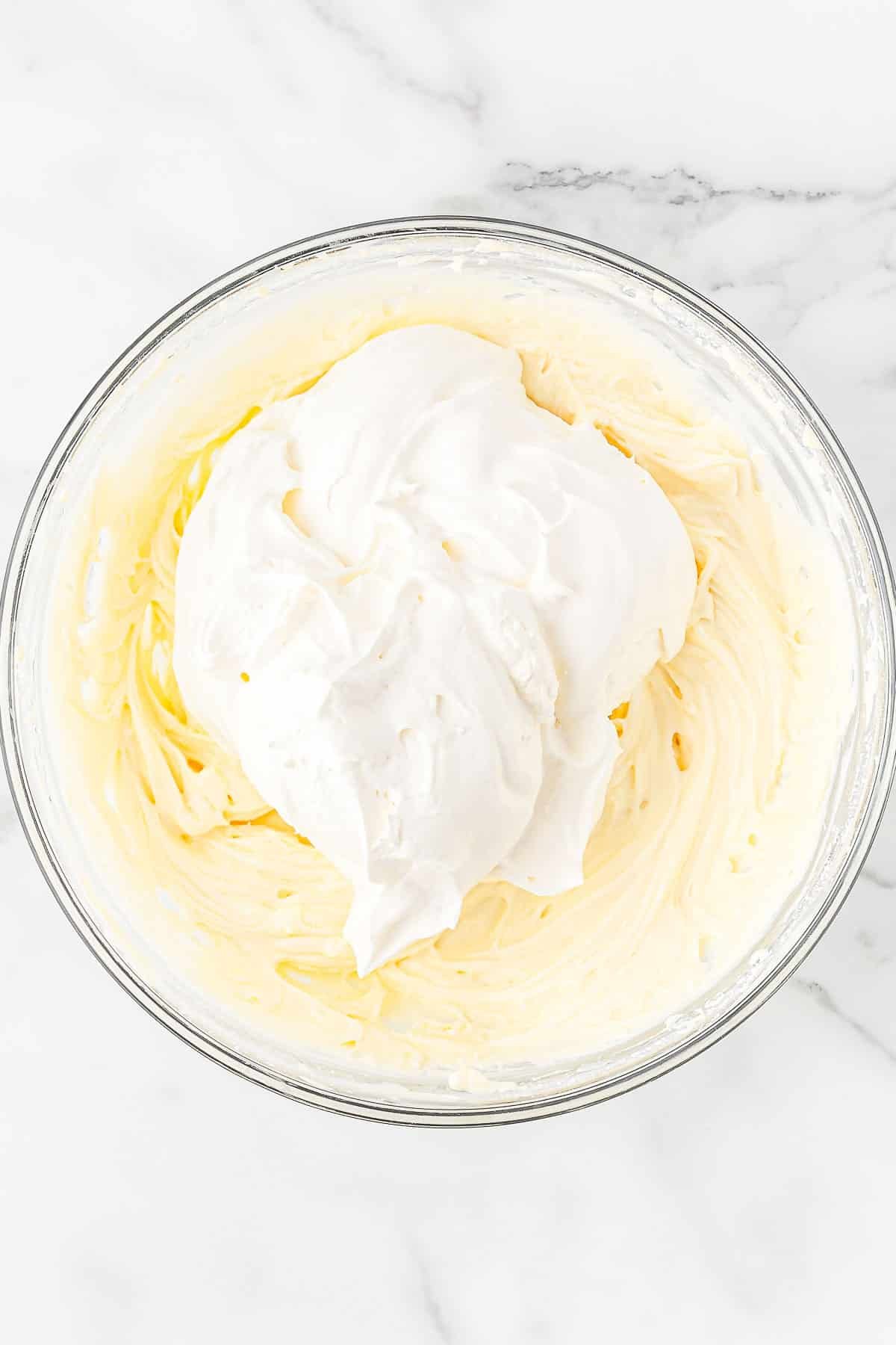 Cream cheese and cool whip in a large mixing bowl.
