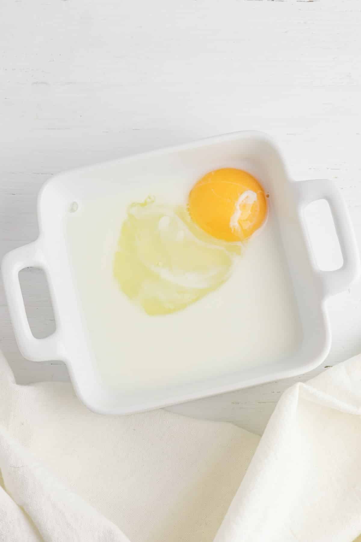 Egg and milk in white glass bowl.