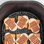 Six cooked smores in air fryer with melted chocolate with text overlay that reads Air Fryer S'mores.