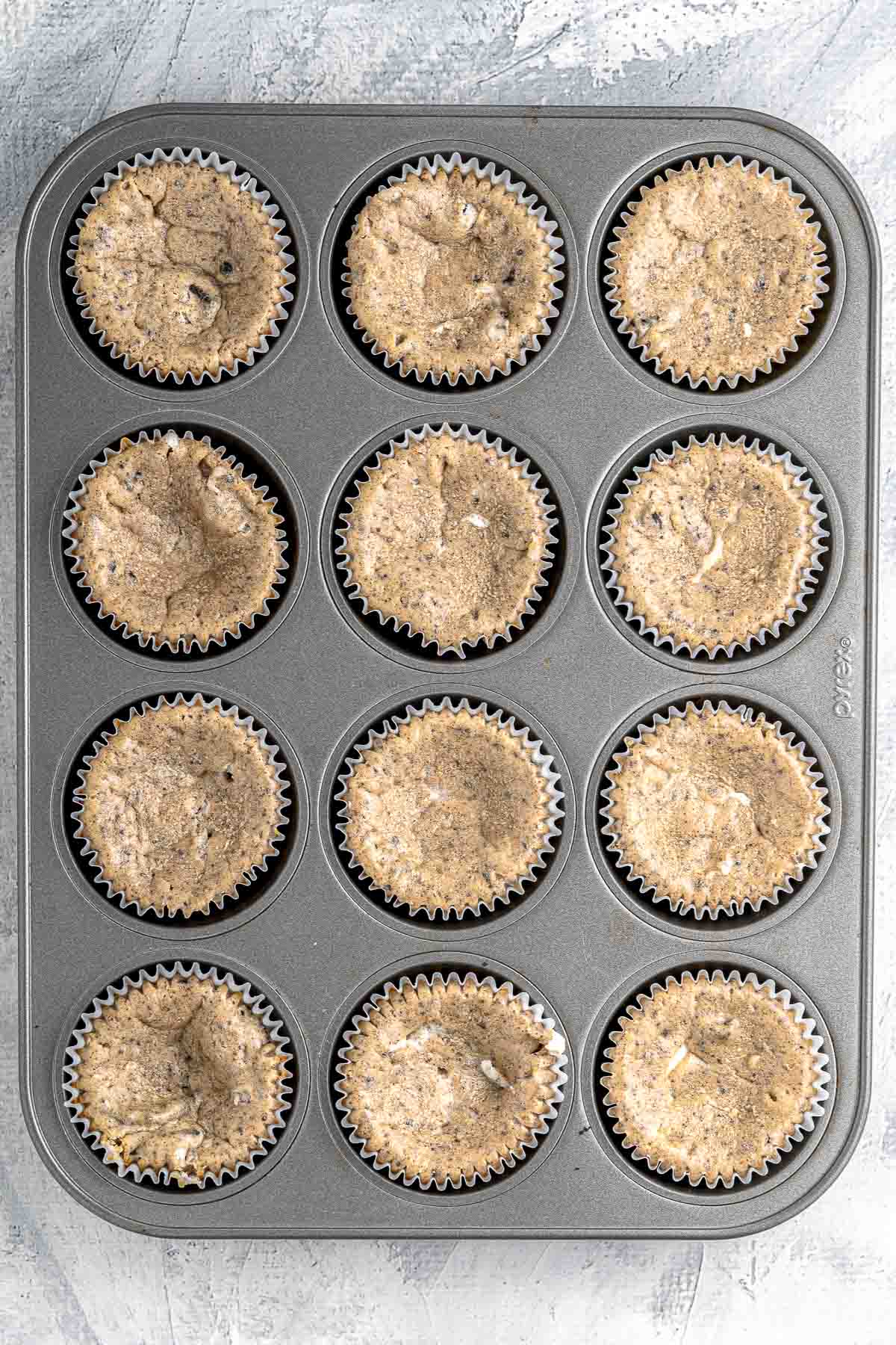 A muffin tin filled with cheesecake cupcakes.