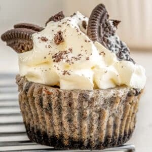 Oreo cupcakes topped with whipped cream and oreos.