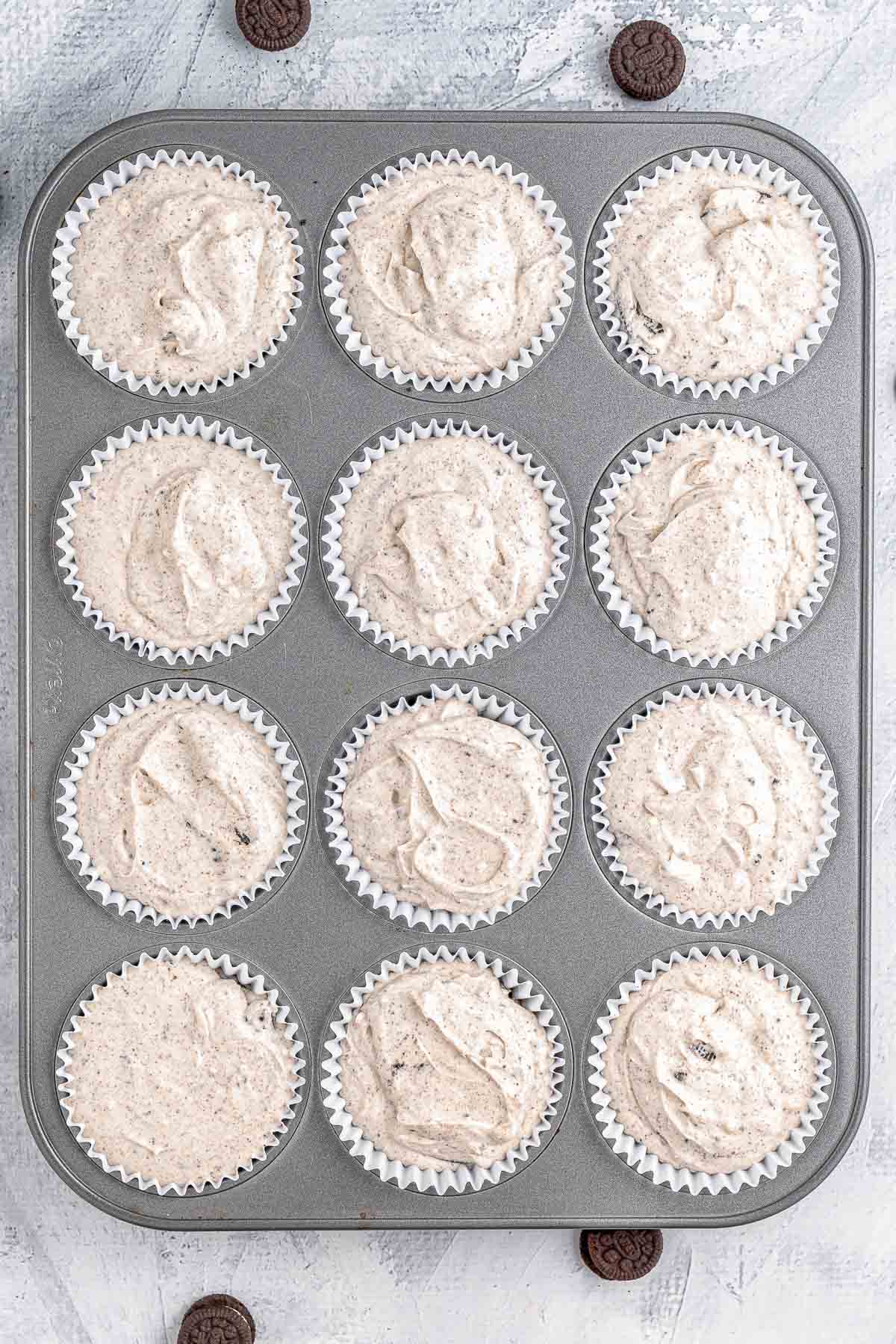 Oreo cupcakes in a muffin tin.
