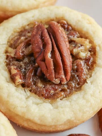 Pecan pie cookies on a white plate.