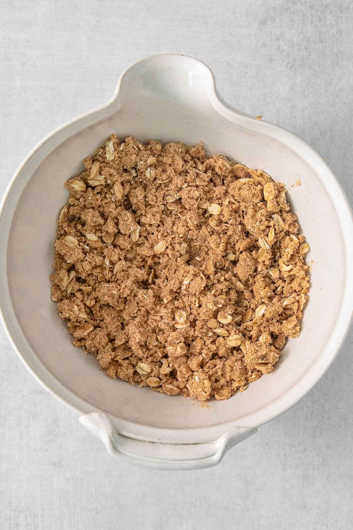Crumble mix in a large white bowl.