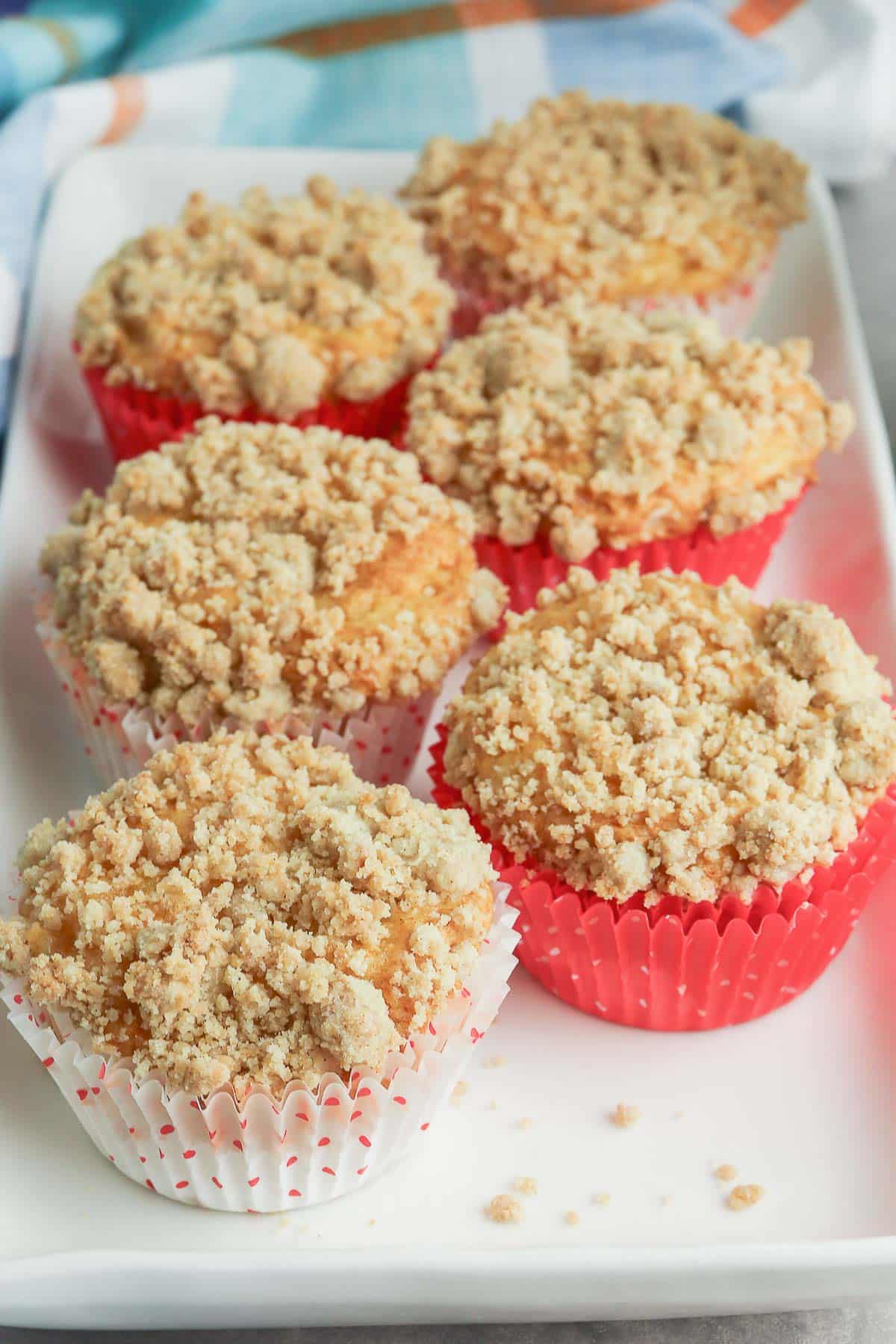 Apple cinnamon muffins on a white plate.