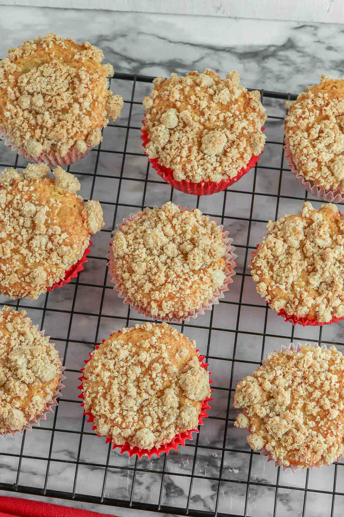 Apple Cinnamon Muffins on a cooling rack with crumb topping.