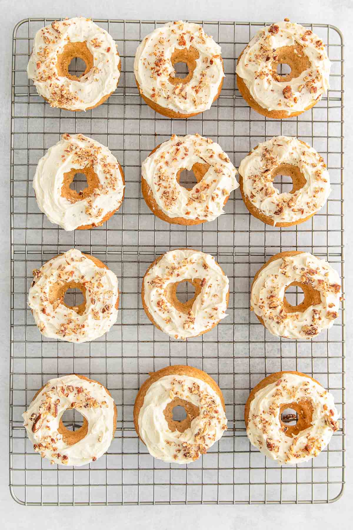 Maple donuts on a wire cooling rack.