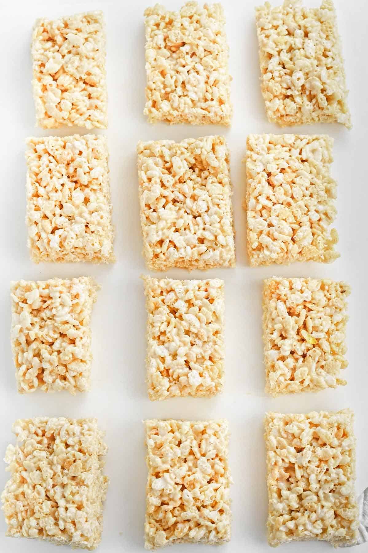 Rice krispie squares on a white surface.