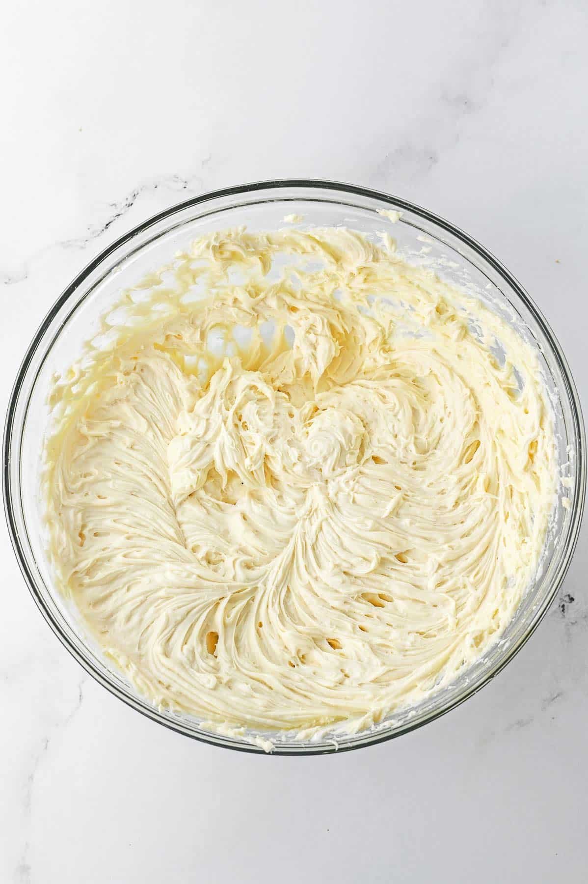Whipped cream cheese mixture in a glass bowl.