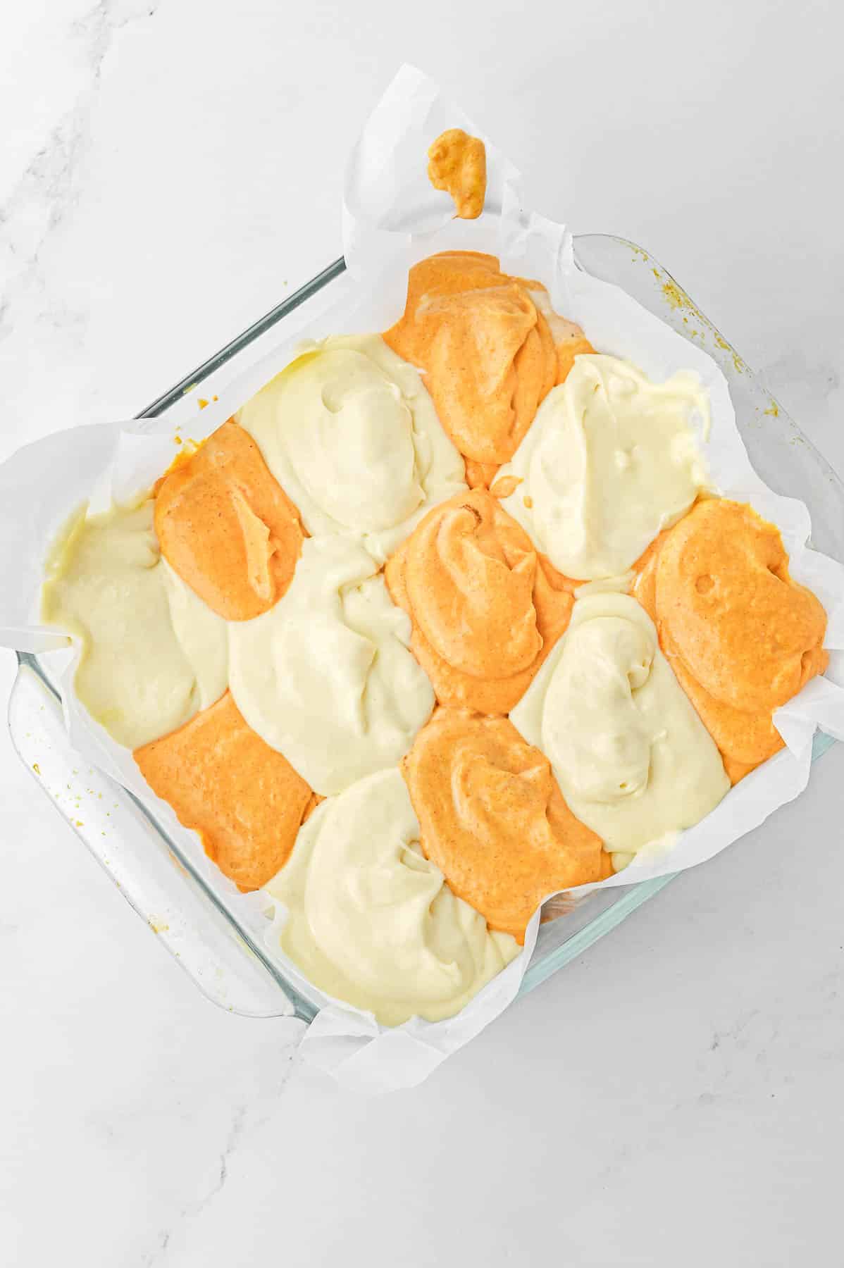 Cheesecake flavors alternating in a large glass baking dish.
