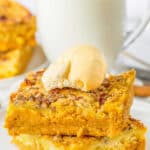 A stack of pumpkin crunch cake on a plate.