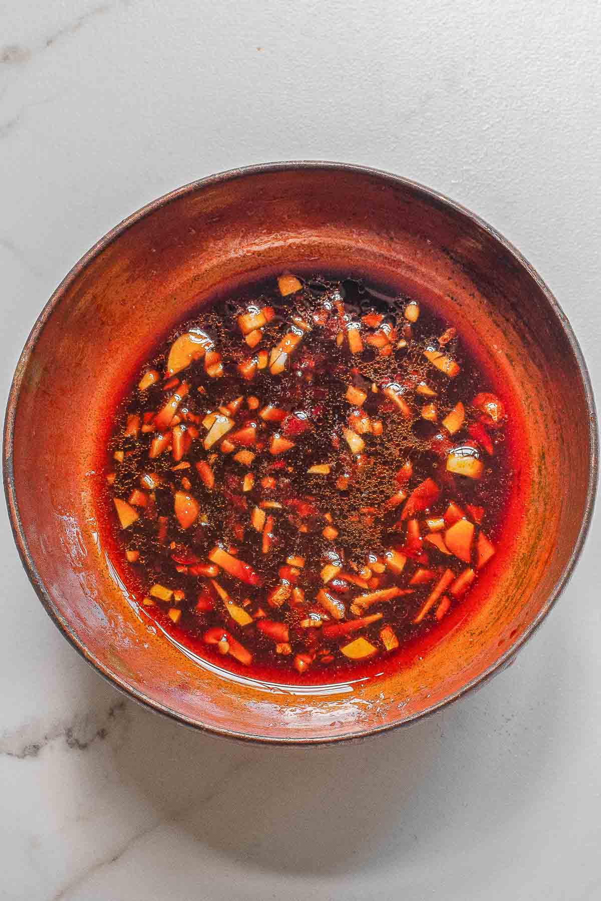 A bowl of cause ingredients mixed together for Thai sauce.