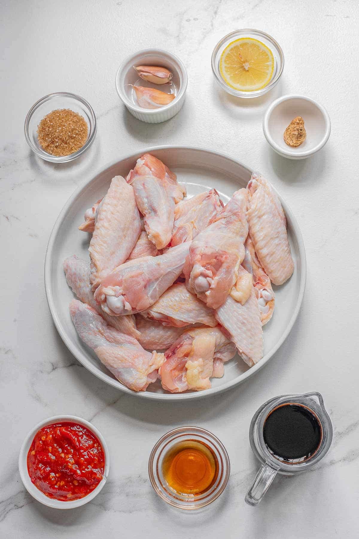 Ingredients for Thai chicken wings - Chicken wings, sesame oil, soy sauce, lemon juice, ginger, chili paste, garlic and brown sugar.