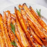 Maple glazed carrots on a white plate.