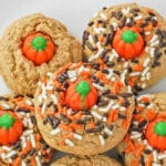 white plate full of spice cookies with mellowcreme pumpkin and fall sprinkles.