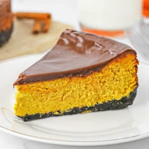 A single slice of chocolate pumpkin cheesecake on a small white plate.