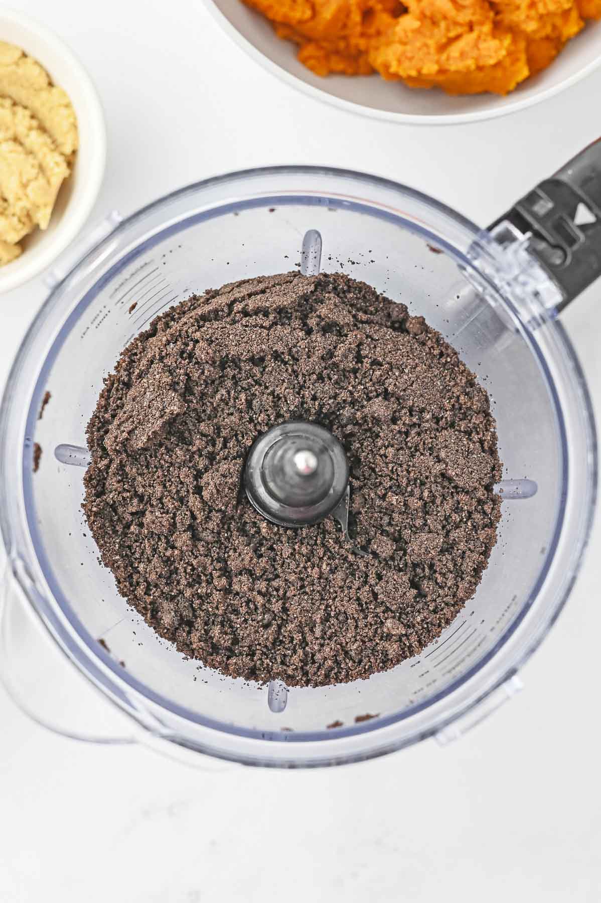 Oreo cookie crumbs in a food processor.