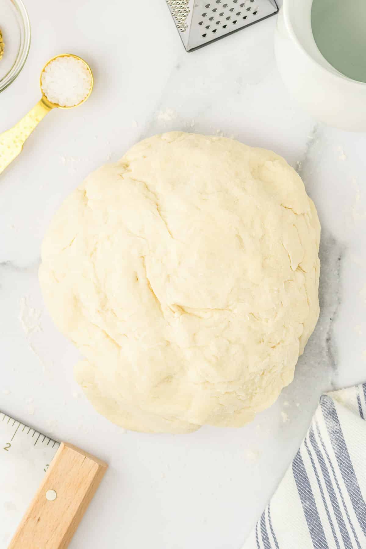 A ball of bread dough on a table.