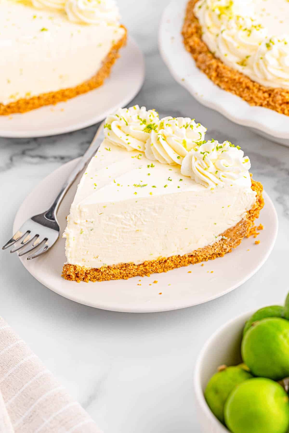 A slice of key lime pie on a white plate.