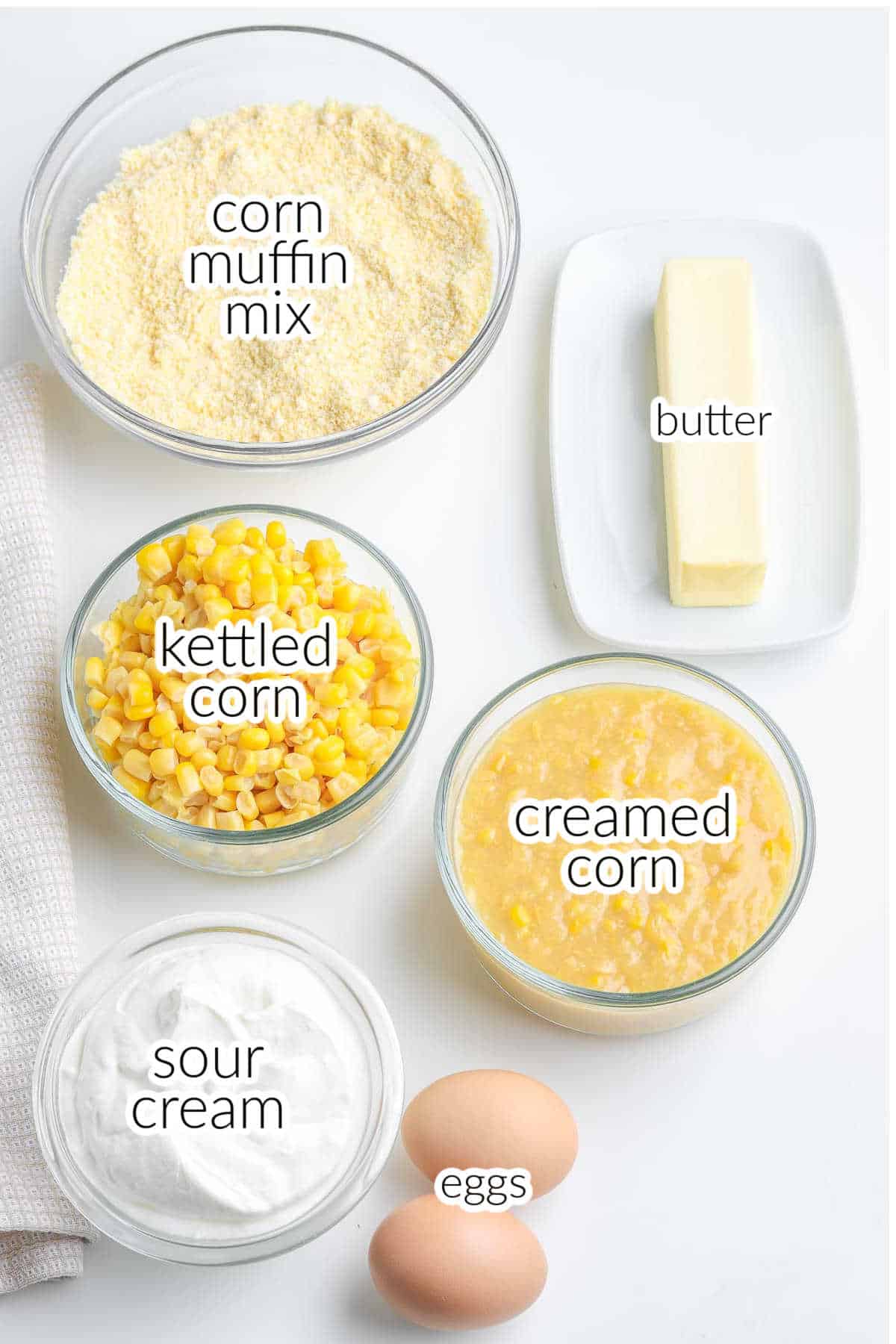 The ingredients for corn casserole - corn muffin mix, eggs, butter, creamed corn, kettled corn and sour cream.