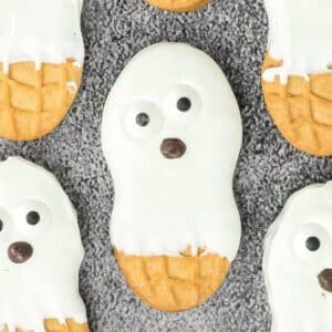 A group of cookies with ghost faces on them.