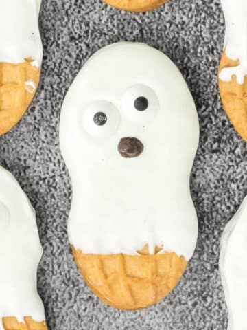 A group of cookies with ghost faces on them.